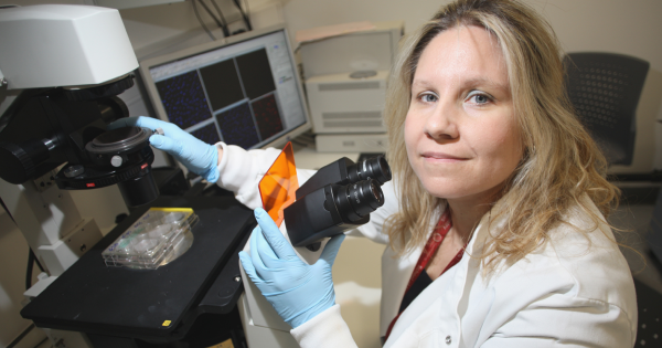 Andriana Margariti using a microscope