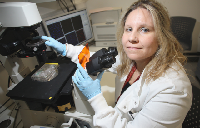 Andriana Margariti using a microscope