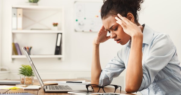 Stressed woman with head in hands 