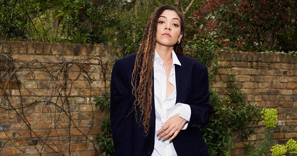 TV Presenter, Miquita Oliver wearing a navy suit and white shirt