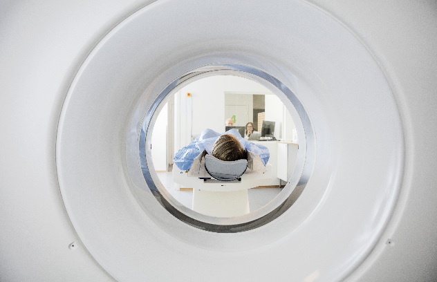 A person entering a CT scan.