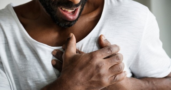 Man clutching chest