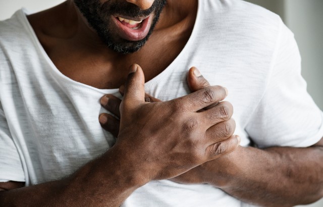 Man clutching chest