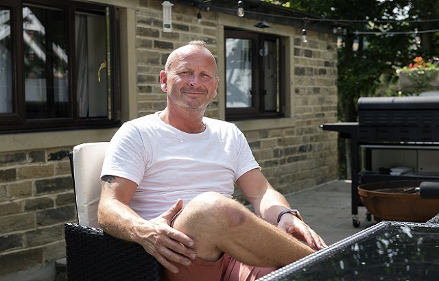BHF supporter James Wilkinson sits in a chair in the garden