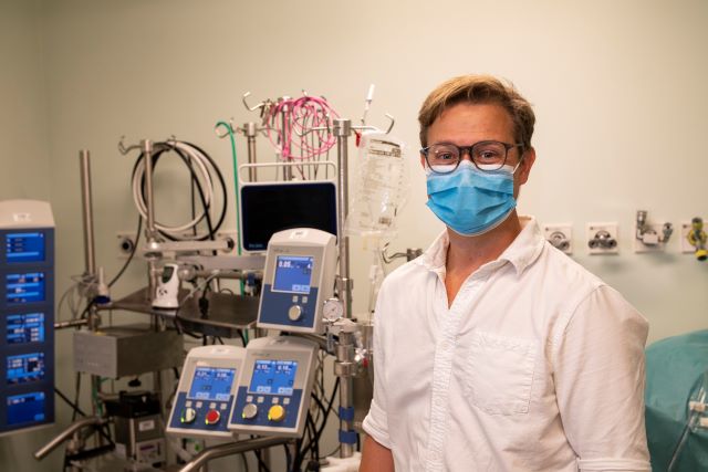 Dr Issitt standing by the device