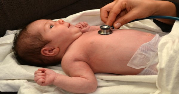 A doctor checking a baby's heart using a stethoscope