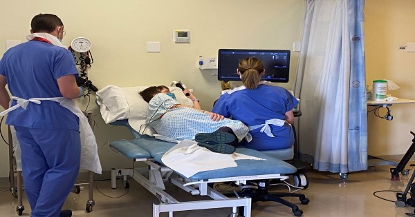 Researchers carry out an echocardiogram on patient Anne Dixon to assess the pumping function of her heart.