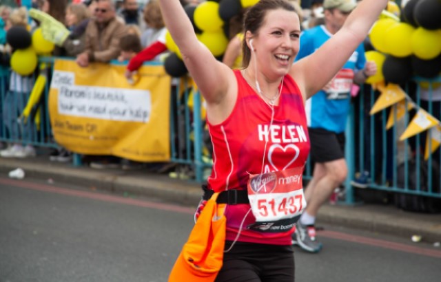 Woman running in British Heart Foundation running top 