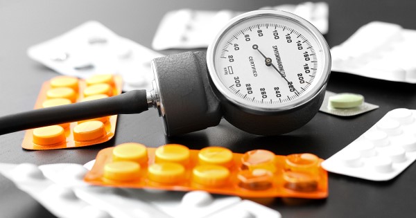 Photograph of tablets in various packets and a Sphygmomanometer (used to measure blood pressure)
