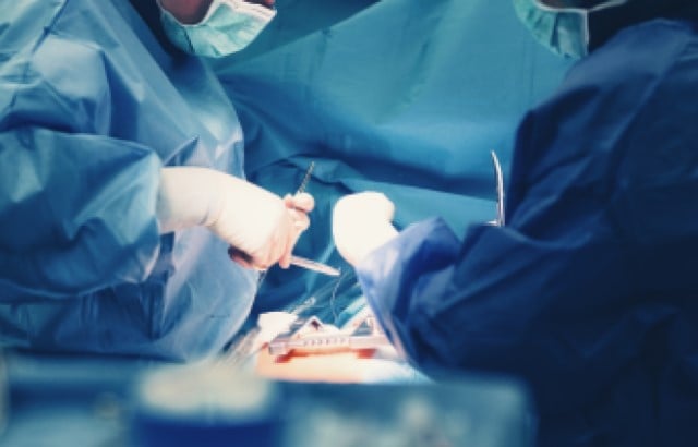 Photograph of two surgeons performing heart surgery