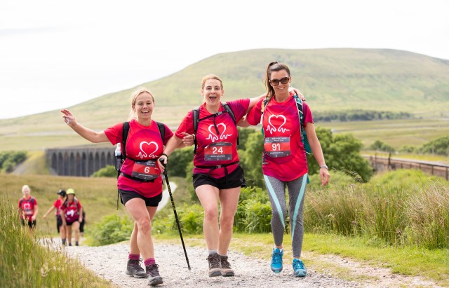 Three women completing trek in Yorkshire countryside