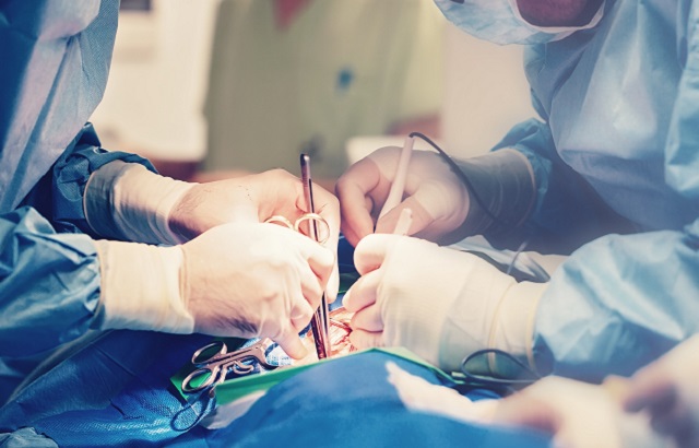 Surgeons performing heart surgery