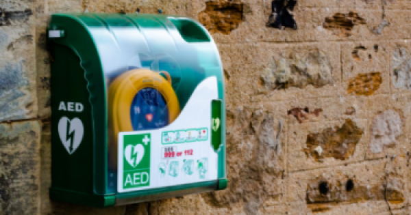 Defibrillator installed on a brick wall. 