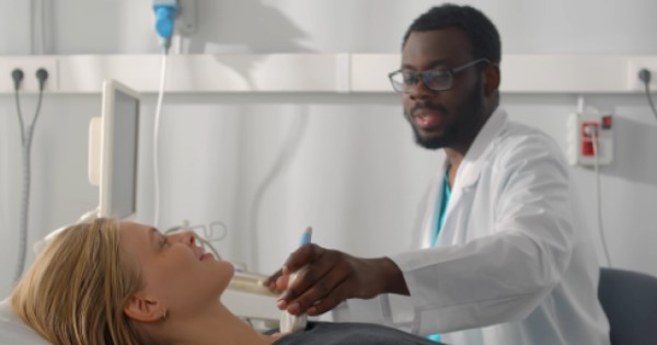 A doctor scans a woman's heart
