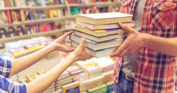 People passing books between them