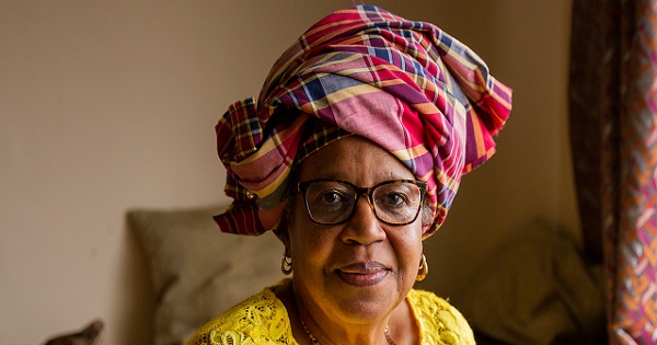 BHF supporter Bettina wearing a beutiful red tartan headscarf and a yellow lacy top
