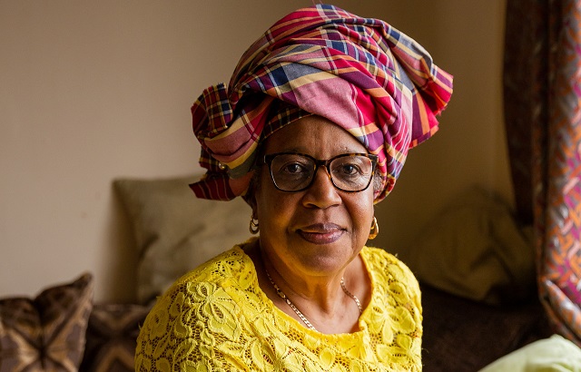 BHF supporter Bettina wearing a beutiful red tartan headscarf and a yellow lacy top