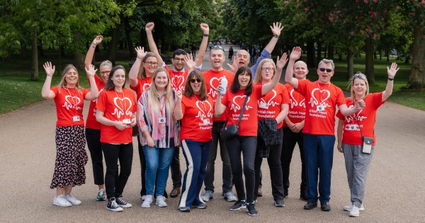 A group of BHF colleagues in red BHF t-shirts celebrate