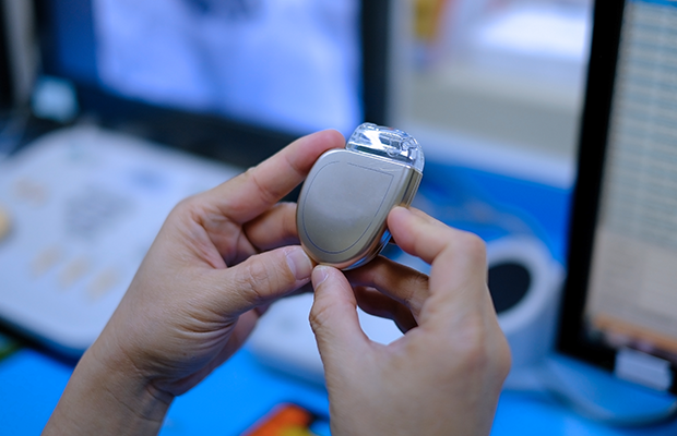 Close up of someone holding a pacemaker