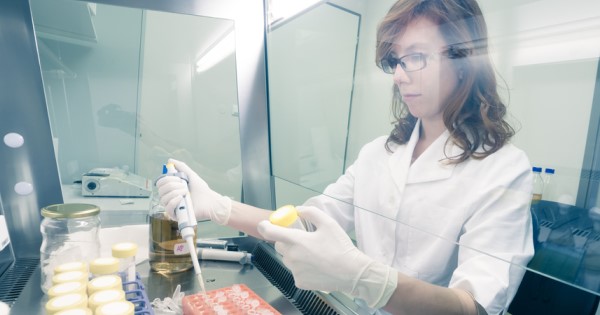 A researcher pipetting