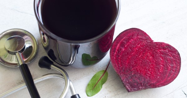 A beetroot, a glass of beetroot juice and a stethoscope