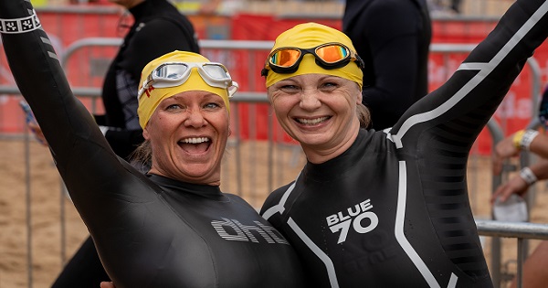Two swimmers smiling at the start line of the Bournemouth Pier to Pier Swim