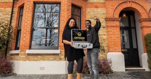  Omaze Million Pound House Draw winner Kevin Johnson with wife Dee outside the winning property