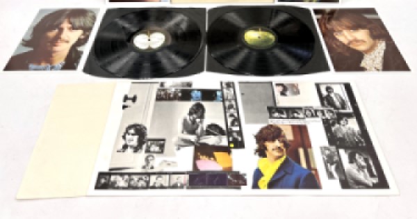 Picture of the Beatles' White Album with posters of the band members and inserts.