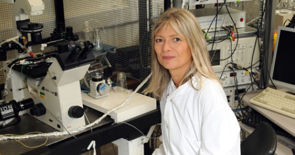 Professor Barbara Casadei sitting at a microscope