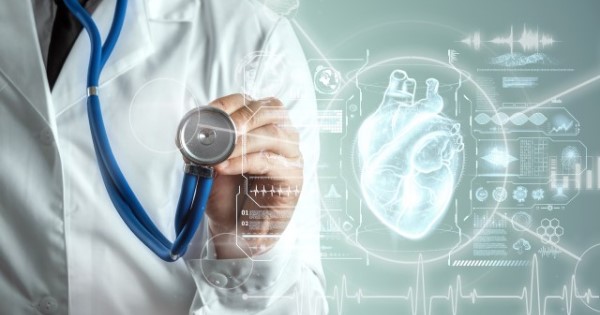 A doctor in a white coat holds a stethoscope up to a screen with a futuristic digital heart next to them.