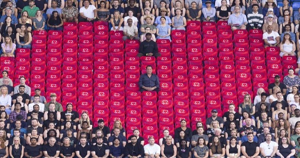 David Seaman sitting in a heart shape made by 180 vacant seats at a Premier League club stadium to represent lives lost to coronary heart disease each day in the UK  