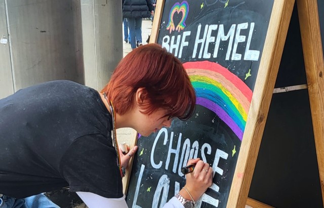 BHF volunteer, 17 year old Anastacia, decorating a chalk board outside the Hemel Hempstead shop.