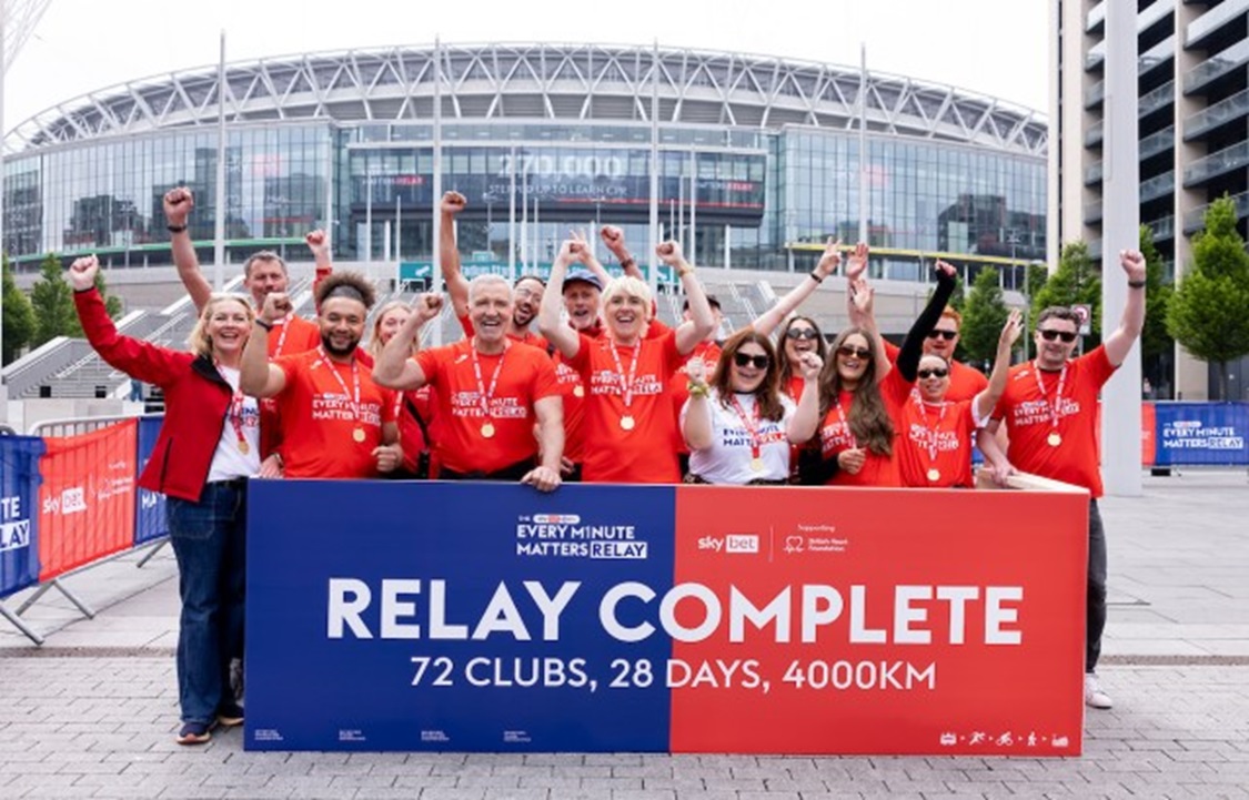 Football legend Graeme Souness and comedian Maisie Adams are joined by BHF and Sky Bet colleagues celebrating the final of the Every Minute Matters Relay outside Wembley Stadium.