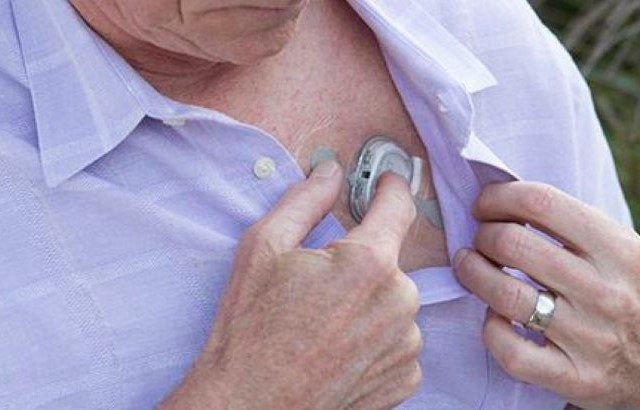 A man sticks the wearable patch used in the study onto his chest