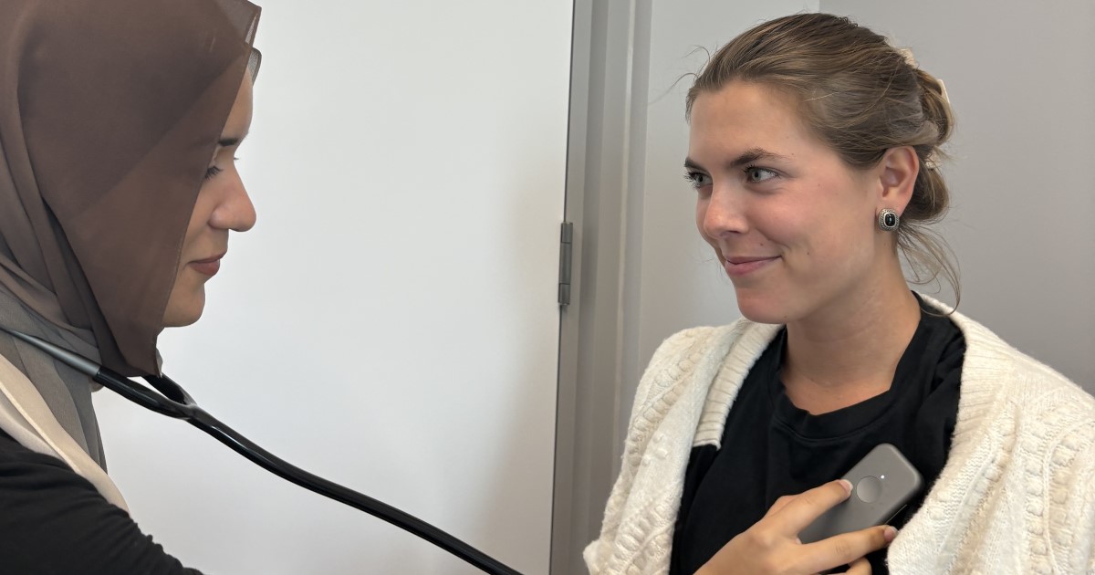 Two women using the AI stethoscope