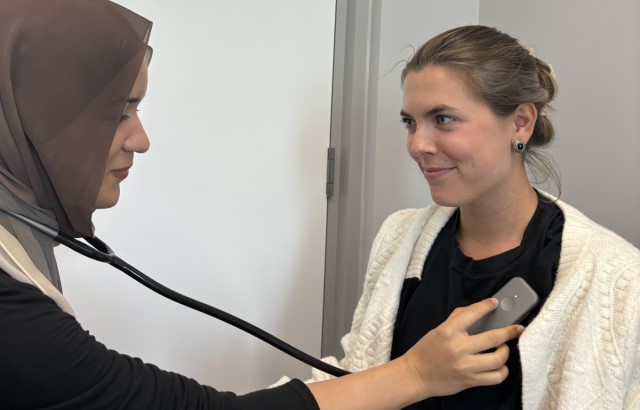 Two women using the AI stethoscope