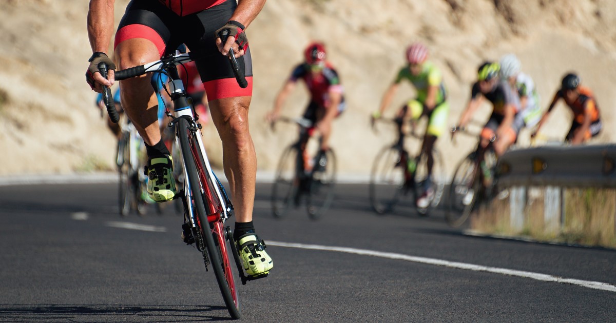Photo of a group of professional cyclists riding up a hill
