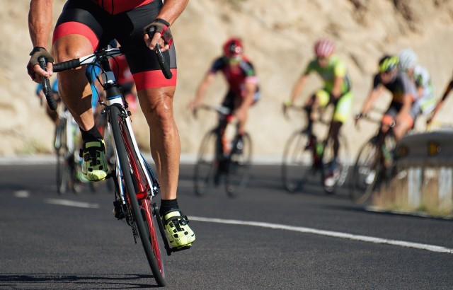 Photo of a group of professional cyclists riding up a hill