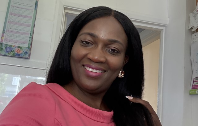 A head and shoulders photo of Joyce Agyara-Twum, a Black woman with long straight black hair. She is wearing a rose pink top and she is smiling.