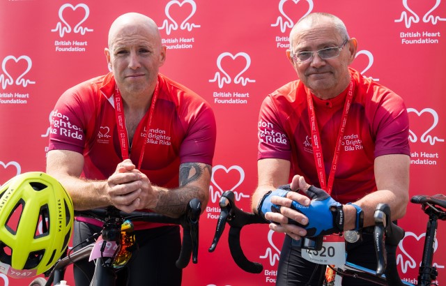 two men in lycra leaning on bikes with medals around their next 