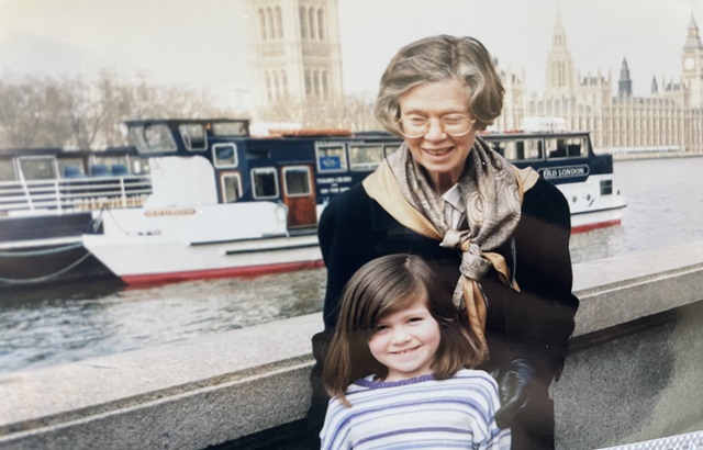 Young girl with her grandmother on a bridge