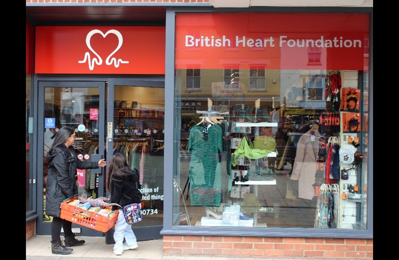 Maia Wiggett donating toys to her local BHF Shop