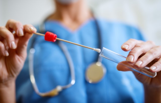 Doctor holding a cheek swab