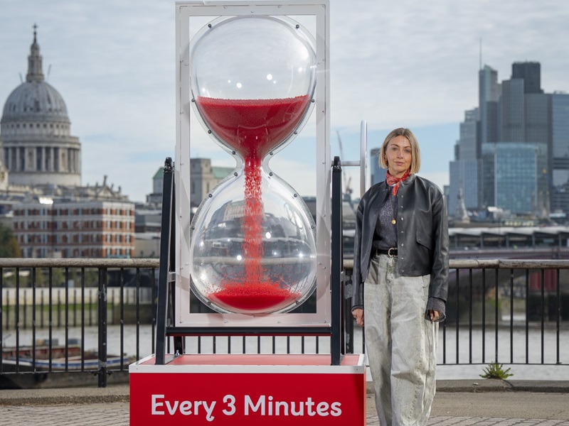 Actress Lisa McGrillis stands by the giant Every 3 minutes egg timer unveiled at London's Southbank