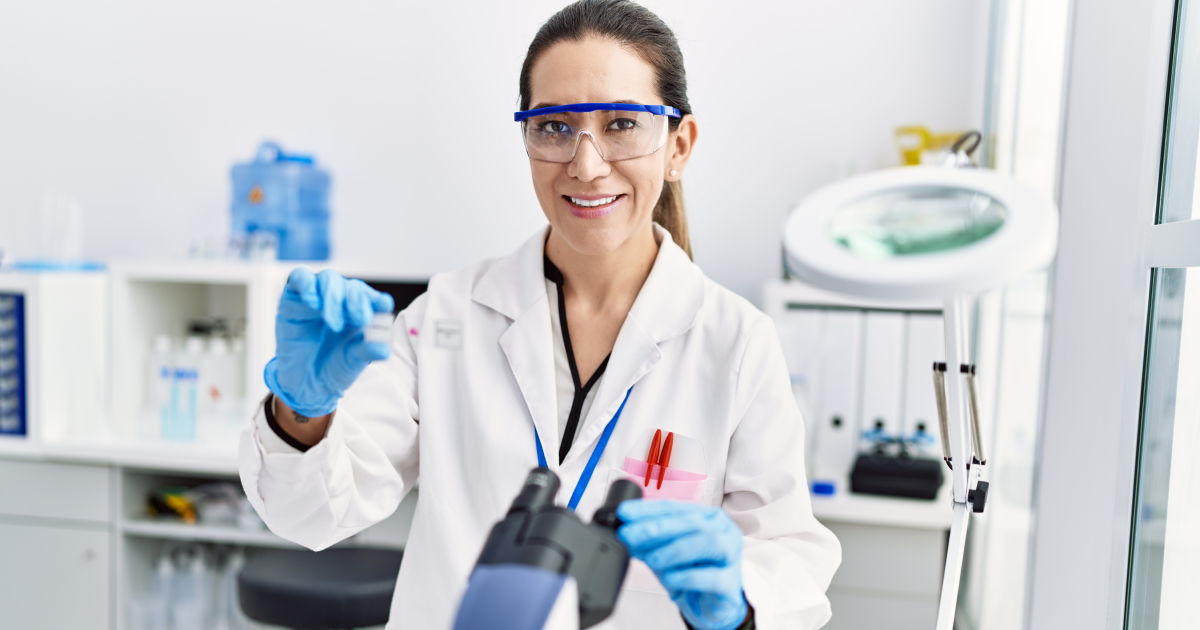 Female scientist in a lab coat and blue gloves