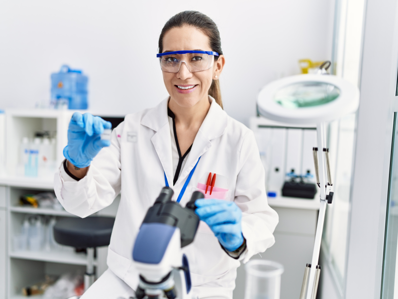 Female scientist in a lab coat and blue gloves