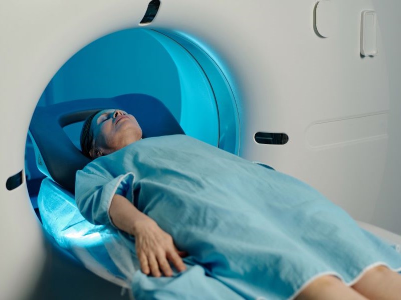 Photograph of a woman in a CT scanner