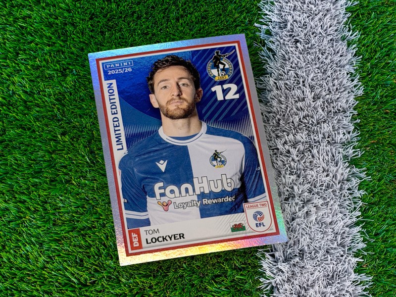 Close up image of Bristol Rovers' Tom Lockyer's special edition Panini card on a football pitch 