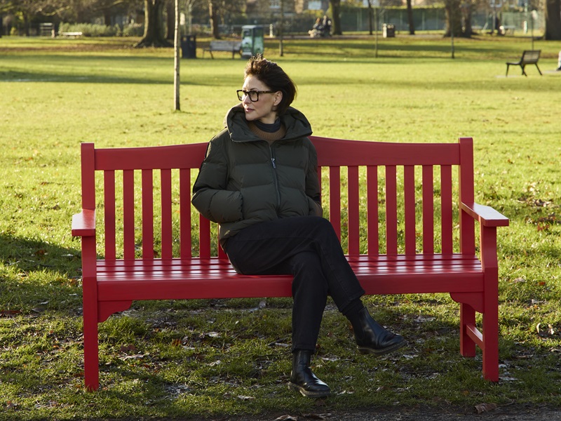 TV presenter Emma Willis sits on a BHF red bench to unveil a new British Heart Foundation campaign