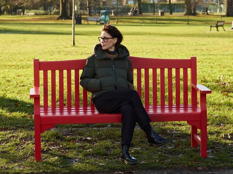 TV presenter Emma Willis sits on a BHF red bench to unveil a new British Heart Foundation campaign
